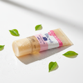 Bioré Massaging Facial Wash Gel editorial product shot with fresh water droplets and green leaves